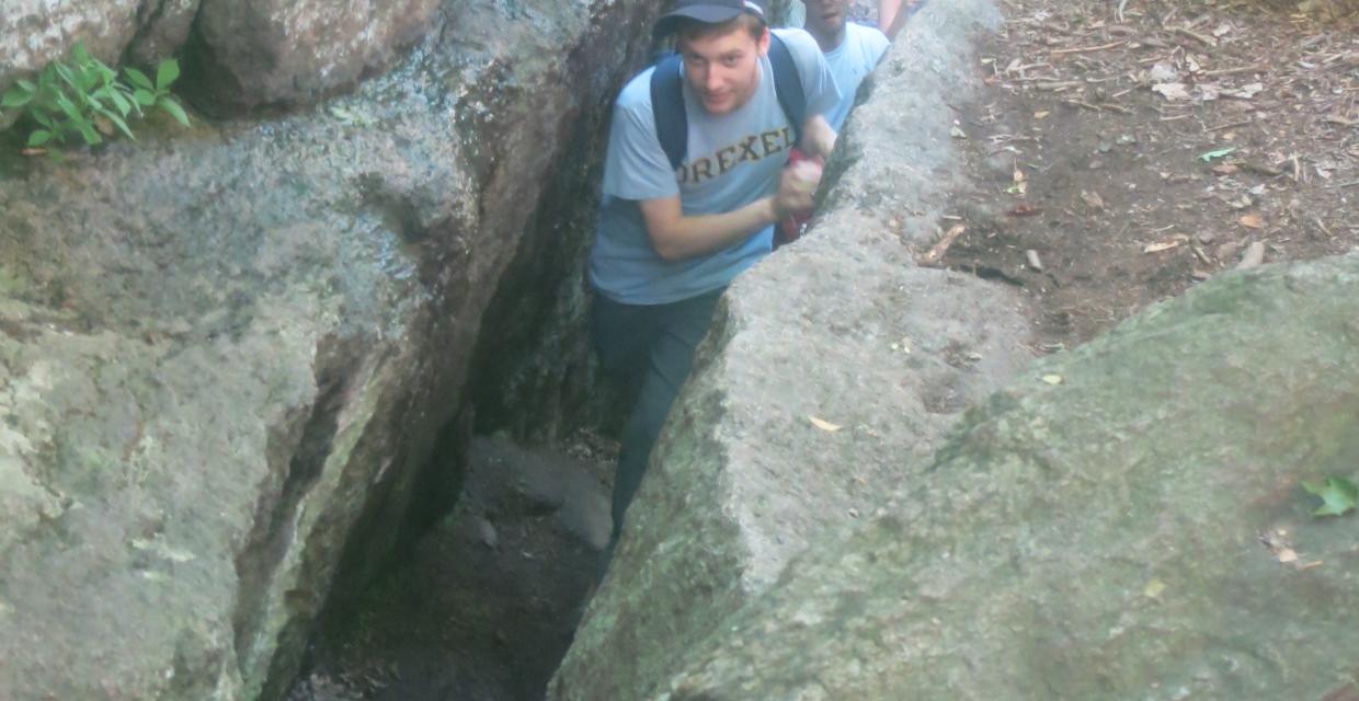 Hikers squeeze through the Lemon Squeezer rock formation. Photo by Daniel Chazin