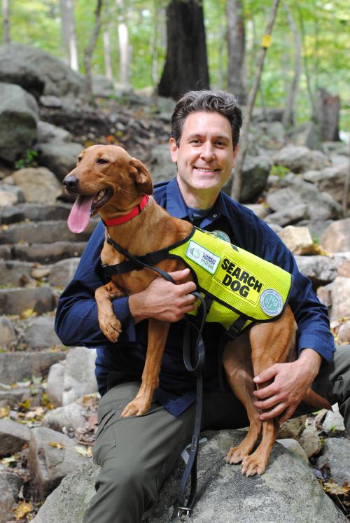 Dia the Conservation Detection Dog and her handler Joshua Beese. Photo by Heather Darley.