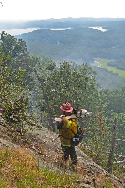 John Livesey on the steep west slope of Windbeam Mtn., Wanaque Reservoir in the background. Photo by James Lisa.