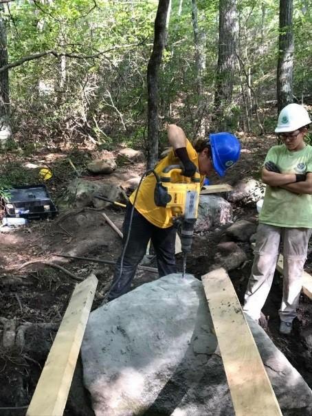 Sam drilling a rock in Sterling Forest State Park.